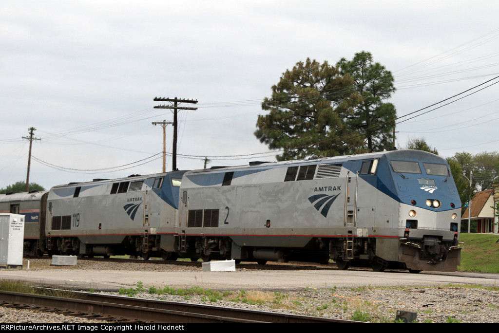 AMTK 2 leads train P092 away from the station